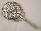 Appraisal: A Chinese white metal hand mirror with jade handle cm