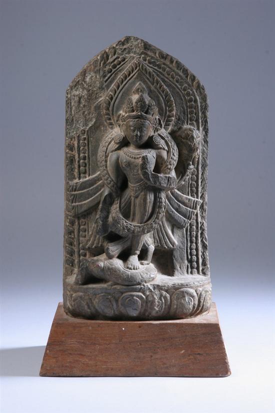 Appraisal: INDIAN GREY STONE FIGURE OF DEITY standing on large waves