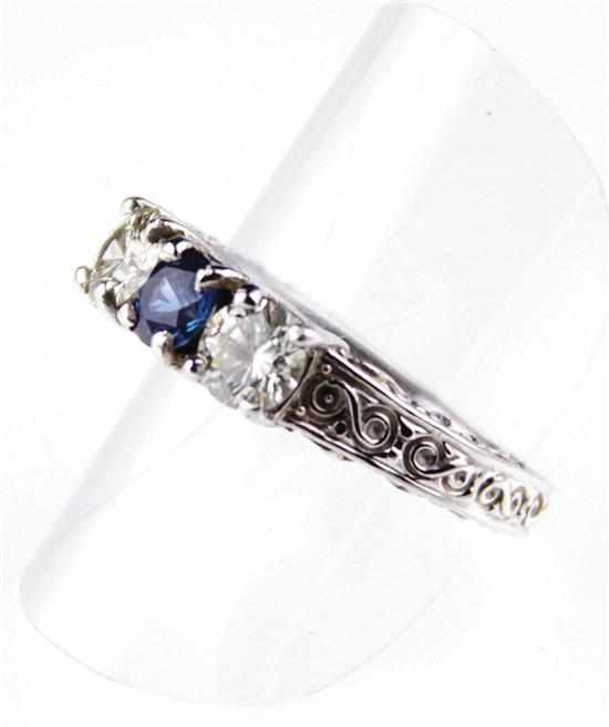 Appraisal: Blue sapphire and diamond ring three stone ring centered by