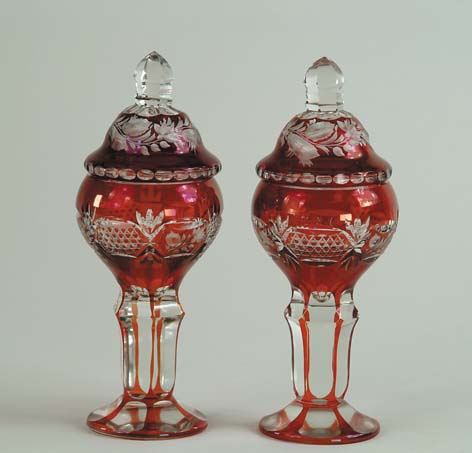 Appraisal: PAIR OF BOHEMIAN OVERLAY RUBY GLASS POKALS WITH COVERS Cut