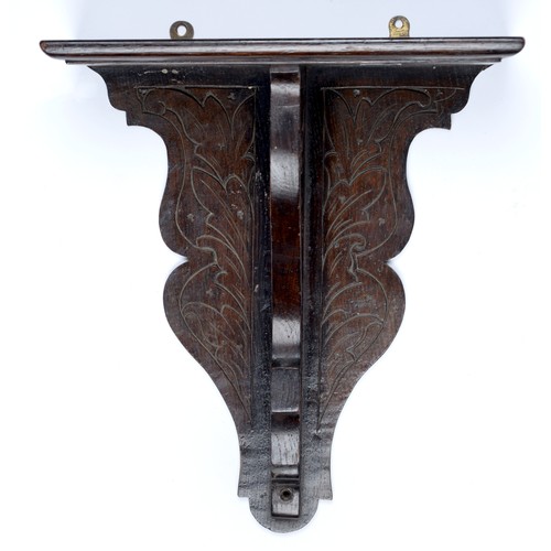 Appraisal: A carved and dark-stained oak clock bracket c cm h