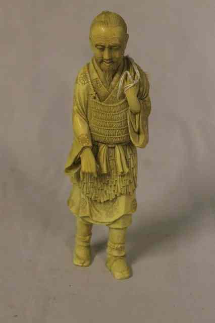 Appraisal: A JAPANESE CARVED IVORY FISHERMAN Meiji period high