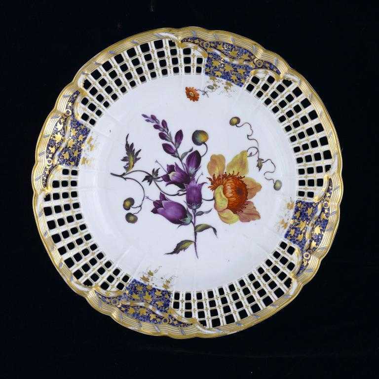 Appraisal: A DERBY RETICULATED PLATE painted by Leonard Lead with colourful