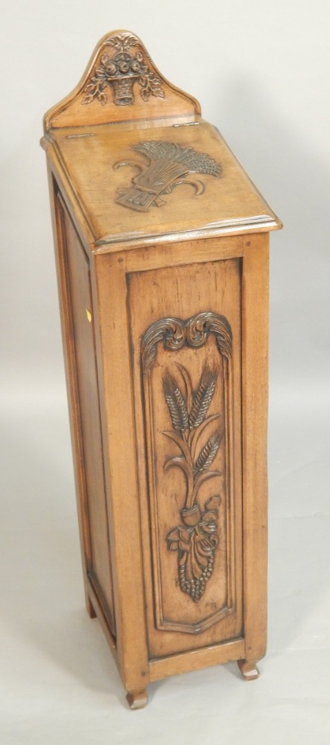 Appraisal: A continental walnut narrow cabinet carved with wheat flower sprays