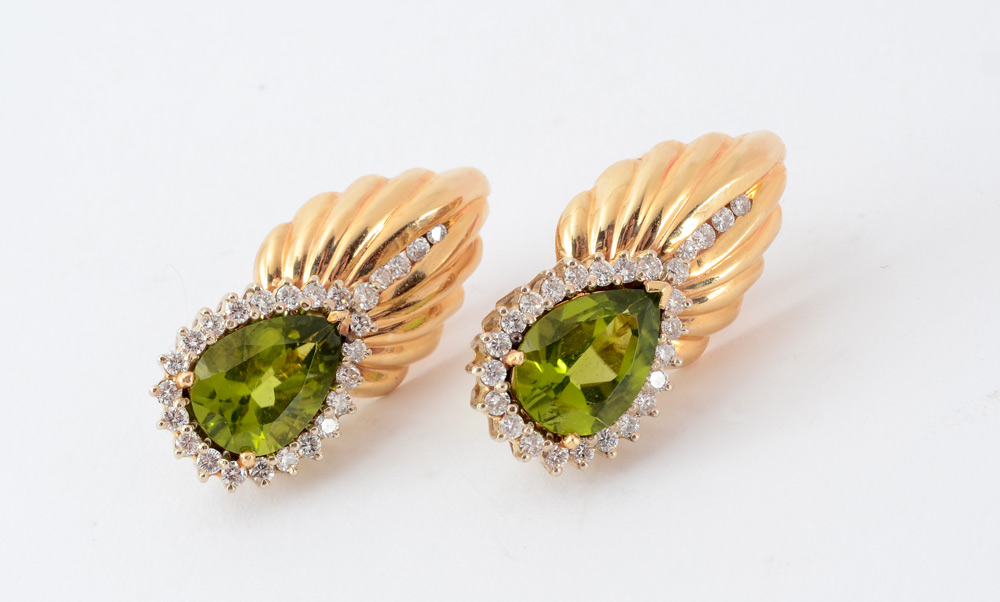 Appraisal: PERIDOT DIAMOND EARRINGS K yellow gold earrings contain two pear