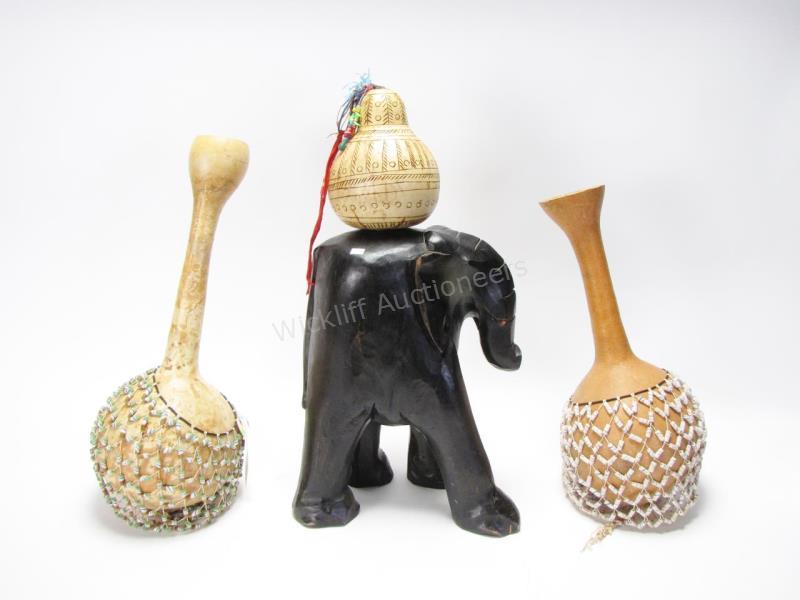 Appraisal: Three African carved gourds two with bead wrap decoration one