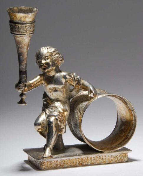 Appraisal: Seated Draped Cherub Figural Napkin Ring Description Tall seated draped