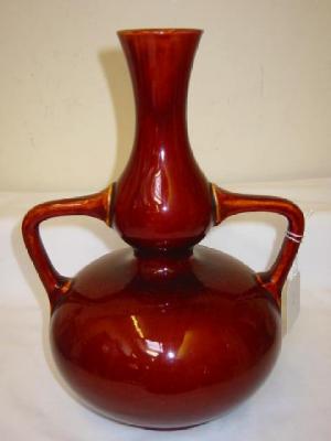 Appraisal: A BURMANTOFTS ART POTTERY RED GLAZED VASE of two handled