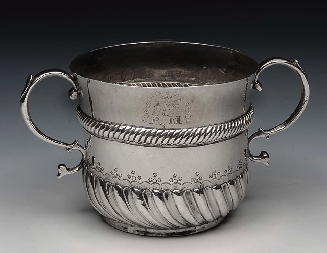 Appraisal: A WILLIAM III BRITANNIA GRADE SILVER PORRINGER with fluted lower