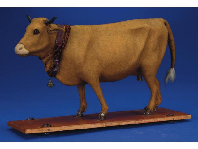 Appraisal: Cow on Platform Pull Toy Germany ca felt covered papier