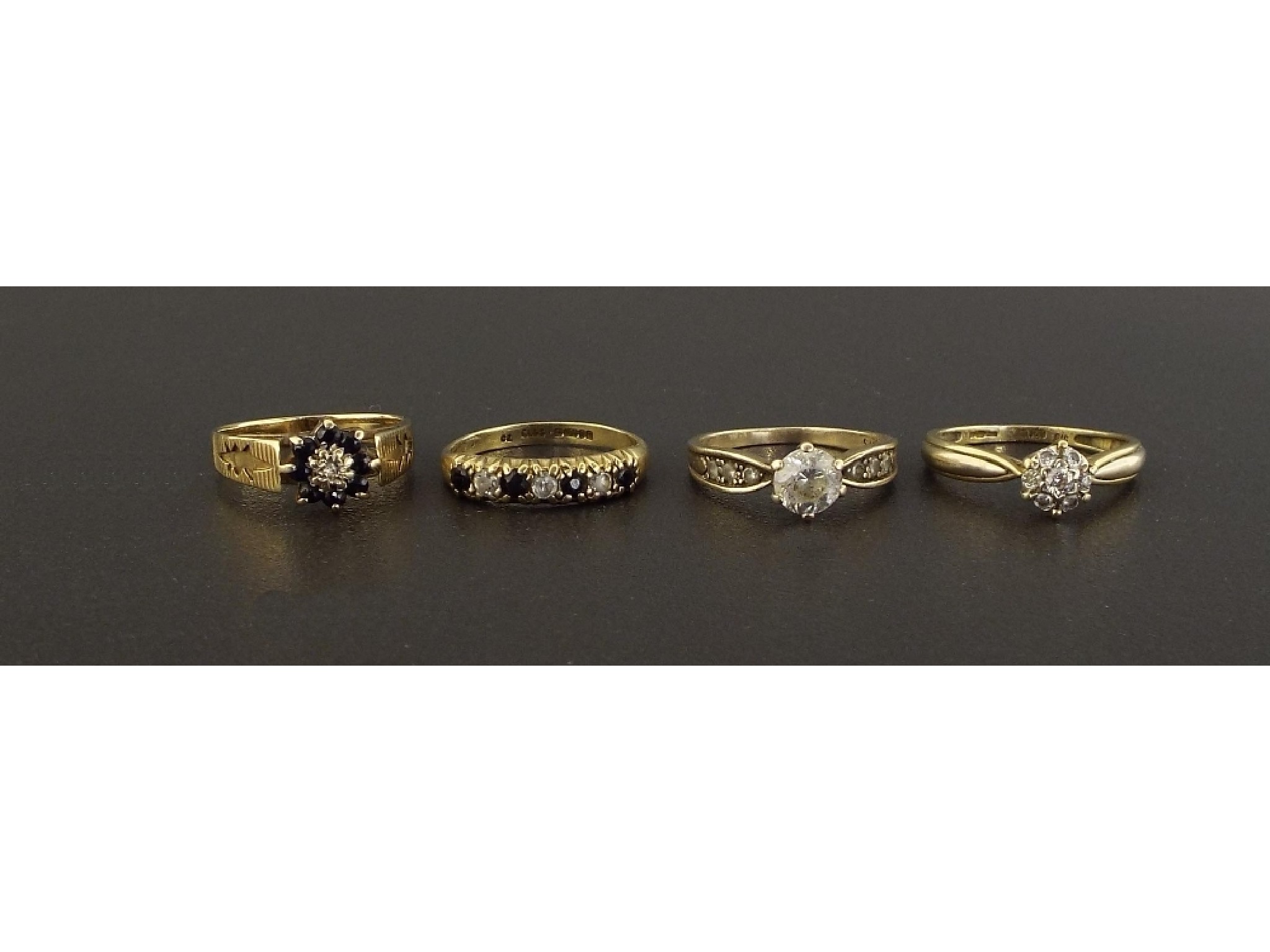 Appraisal: Four assorted ct dress rings including a diamond cluster ring