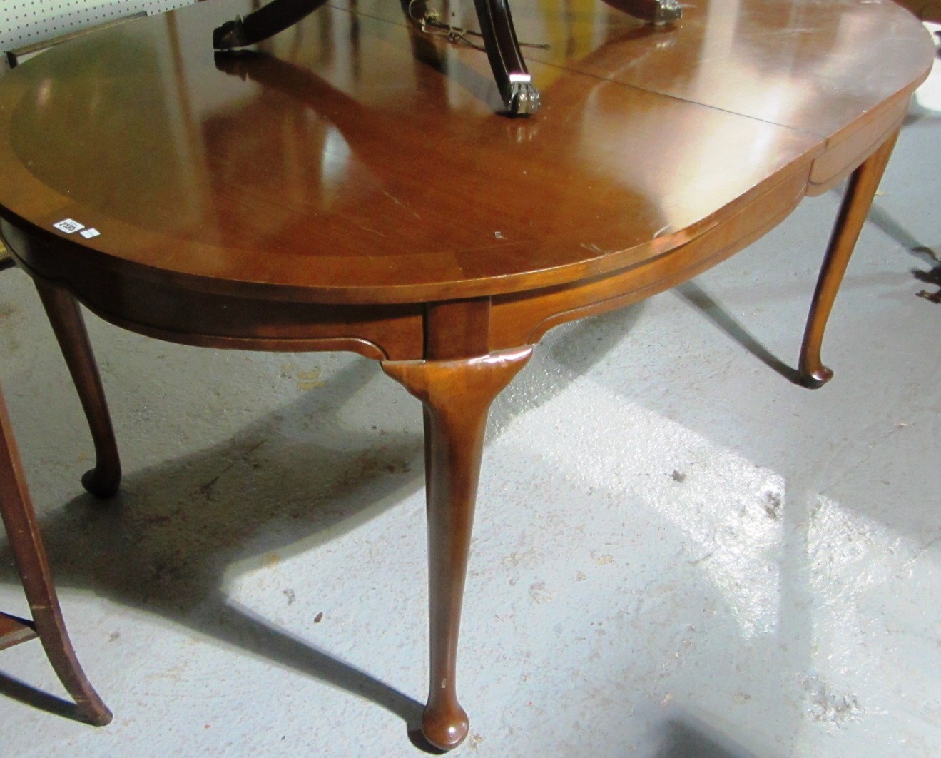 Appraisal: A th century mahogany dining table with two extra leaves