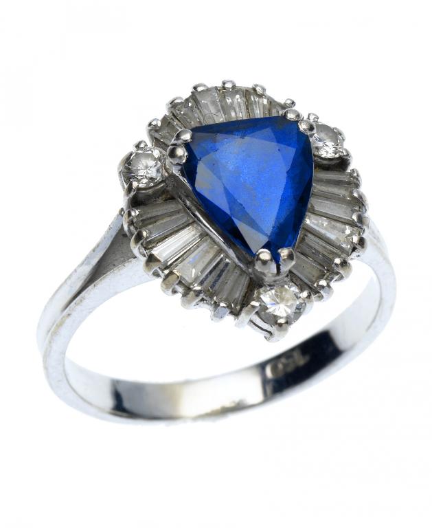 Appraisal: A SAPPHIRE AND DIAMOND RING the almost pear shaped sapphire