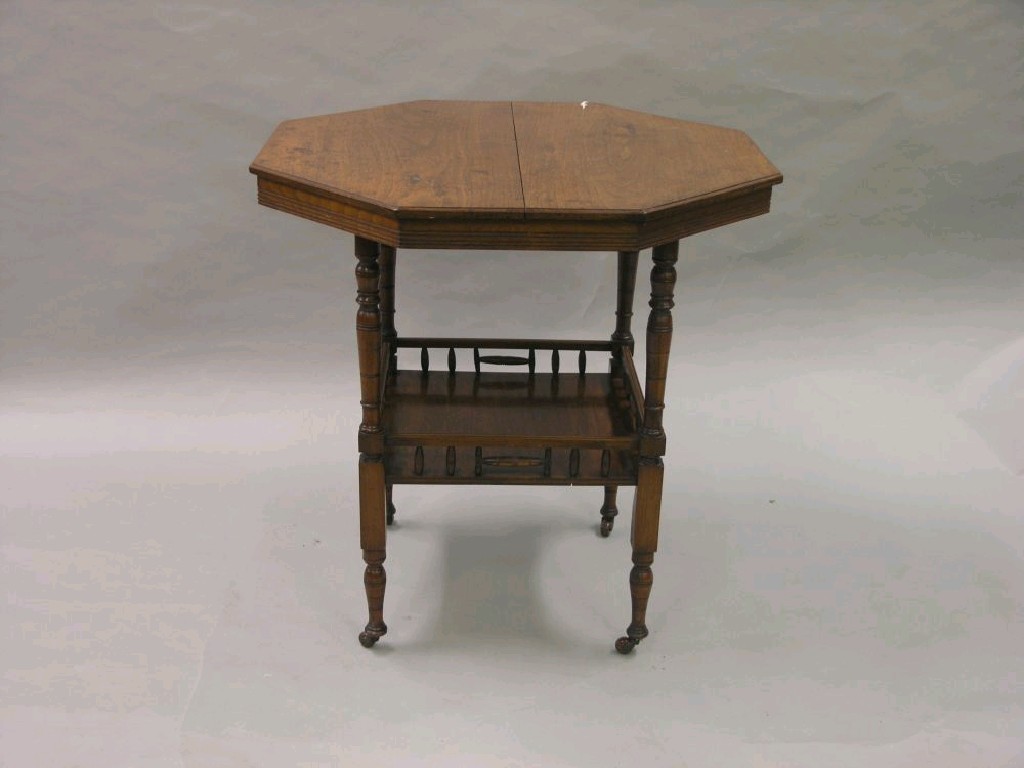 Appraisal: An Edwardian walnut centre table octagonal top above galleried undertier