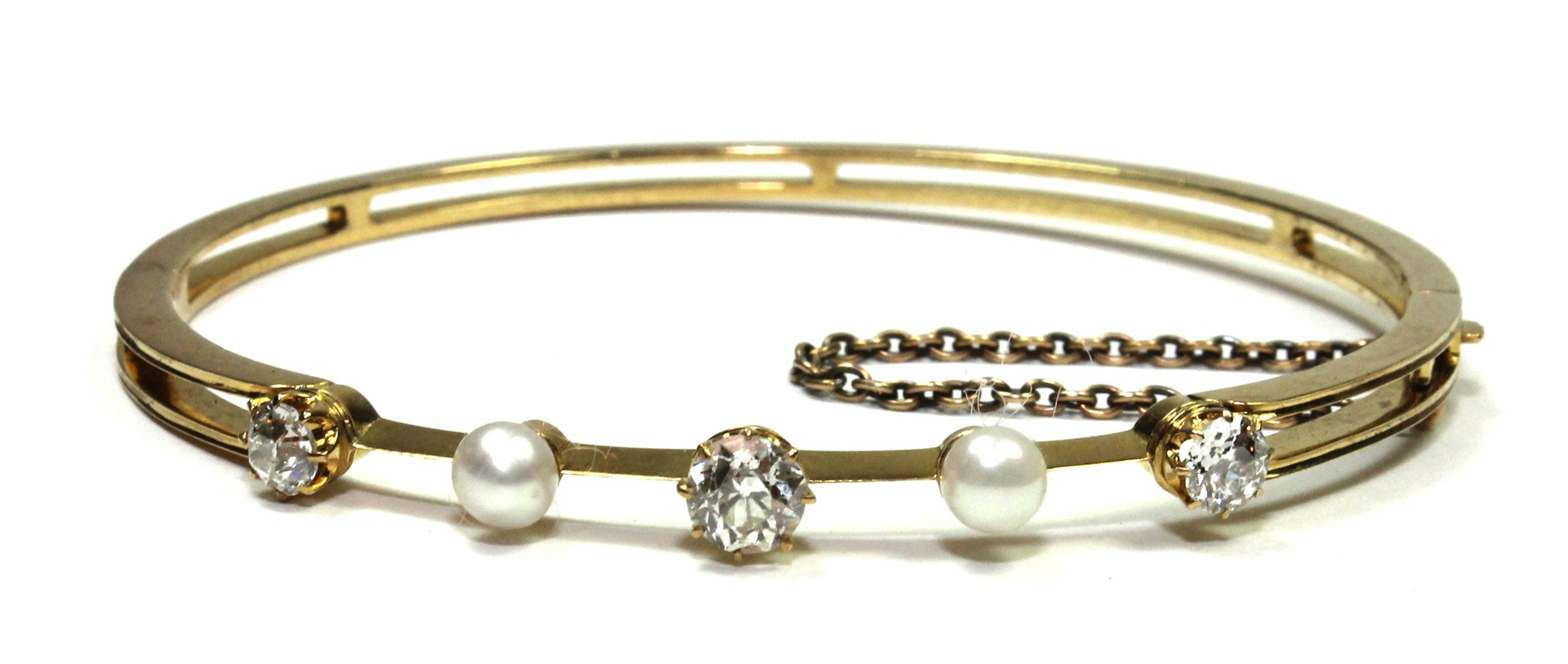 Appraisal: A gold diamond and cultured pearl set oval hinged bangle