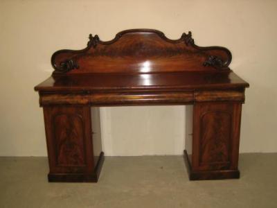 Appraisal: A VICTORIAN MAHOGANY PEDESTAL SIDEBOARD the arched panel back with