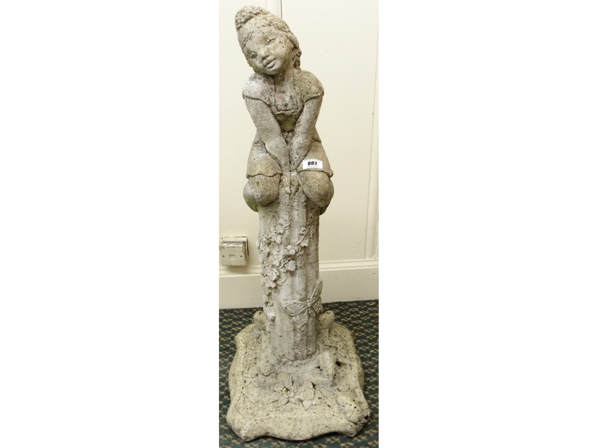 Appraisal: A cast stone figure of a girl sitting on a