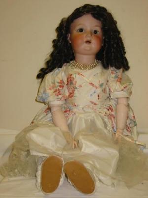 Appraisal: An Armand Marseille bisque head girl doll with brown glass