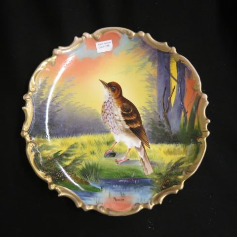 Appraisal: Handpainted Porcelain Charger with Bird Thrasher fancy gold rim circa