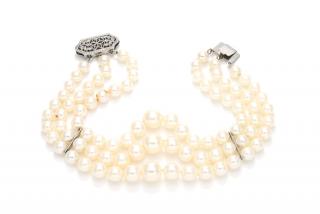 Appraisal: A THREE-STRAND PEARL BRACELETGraduated knotted pearls terminated in a K