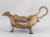 Appraisal: A large silver sauceboat with leaf capped handle acanthus pad