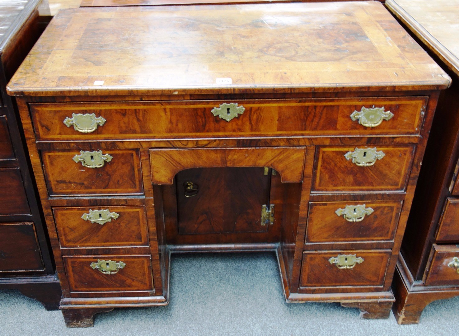 Appraisal: An th century feather-banded figured walnut kneehole writing table with