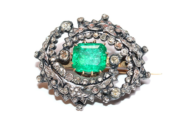 Appraisal: A VICTORIAN EMERALD AND DIAMOND BROOCH central emerald cut emerald