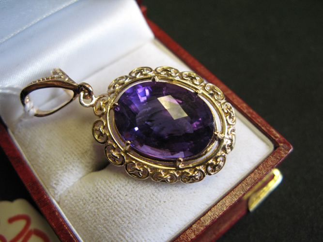 Appraisal: AMETHYST AND FOURTEEN KARAT GOLD PENDANT set with an oval-cut