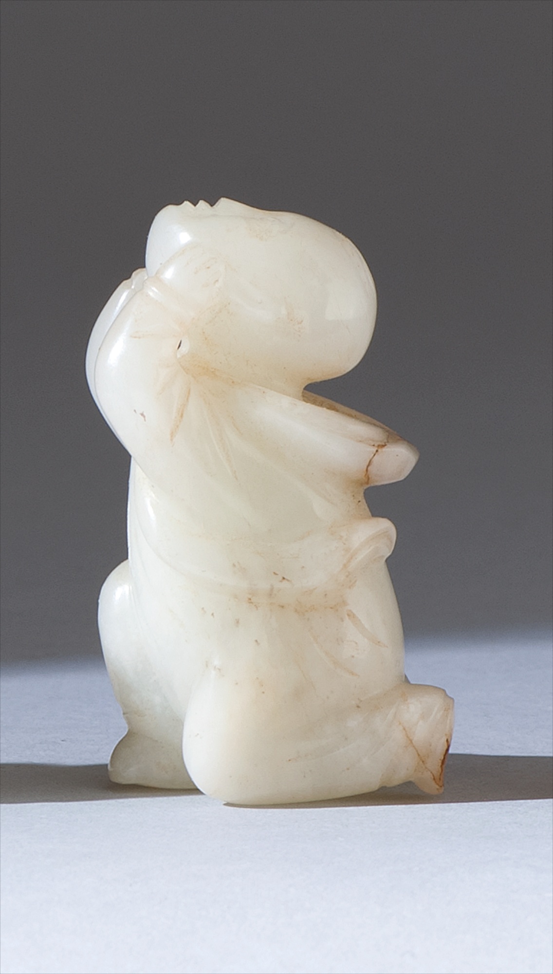 Appraisal: WHITE JADE CARVING th CenturyIn the form of a kneeling