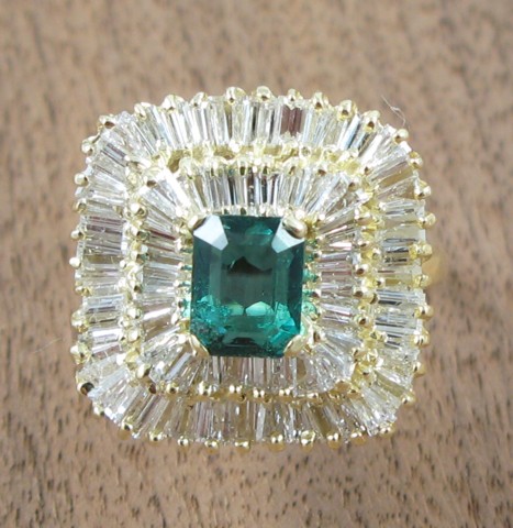 Appraisal: EMERALD AND FOURTEEN KARAT GOLD RING centering an emerald-cut green