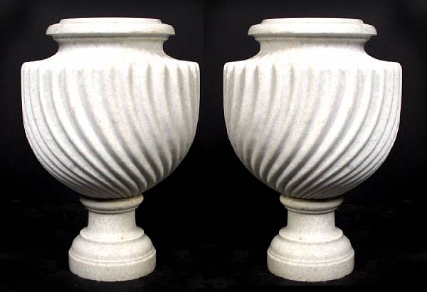 Appraisal: A pair of Neoclassical style carved marble urns height in