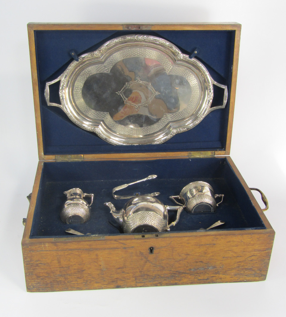 Appraisal: A Victorian silver tea set with engraved basket weave and