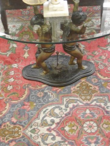 Appraisal: GLASS TOP COFFEE TABLE W BRONZE CHERUB BASE