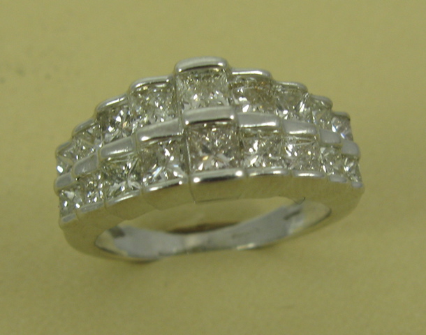 Appraisal: DIAMOND AND FOURTEEN KARAT WHITE GOLD RING set with princess-cut