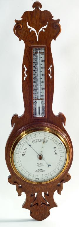 Appraisal: EDWARDIAN GOLDEN OAK BANJO BAROMETER carved and pierced with whiplash