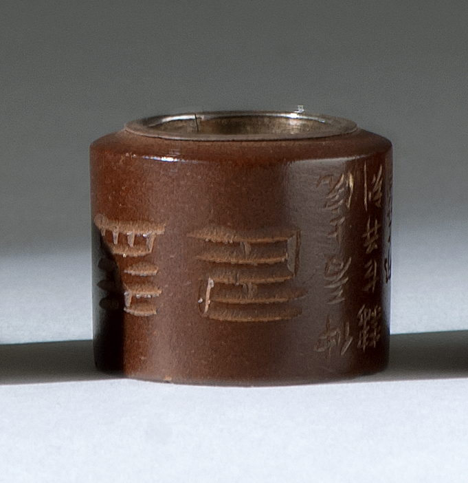 Appraisal: CASED CARVED WOOD THUMB RING th CenturyWith fine calligraphic decoration