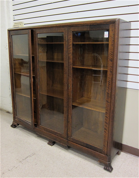 Appraisal: THREE DOOR OAK CABINET BOOKCASE American c the whole divided