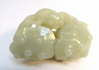 Appraisal: White Jade Carving A lotus root intertwined with goldfish Dimensions