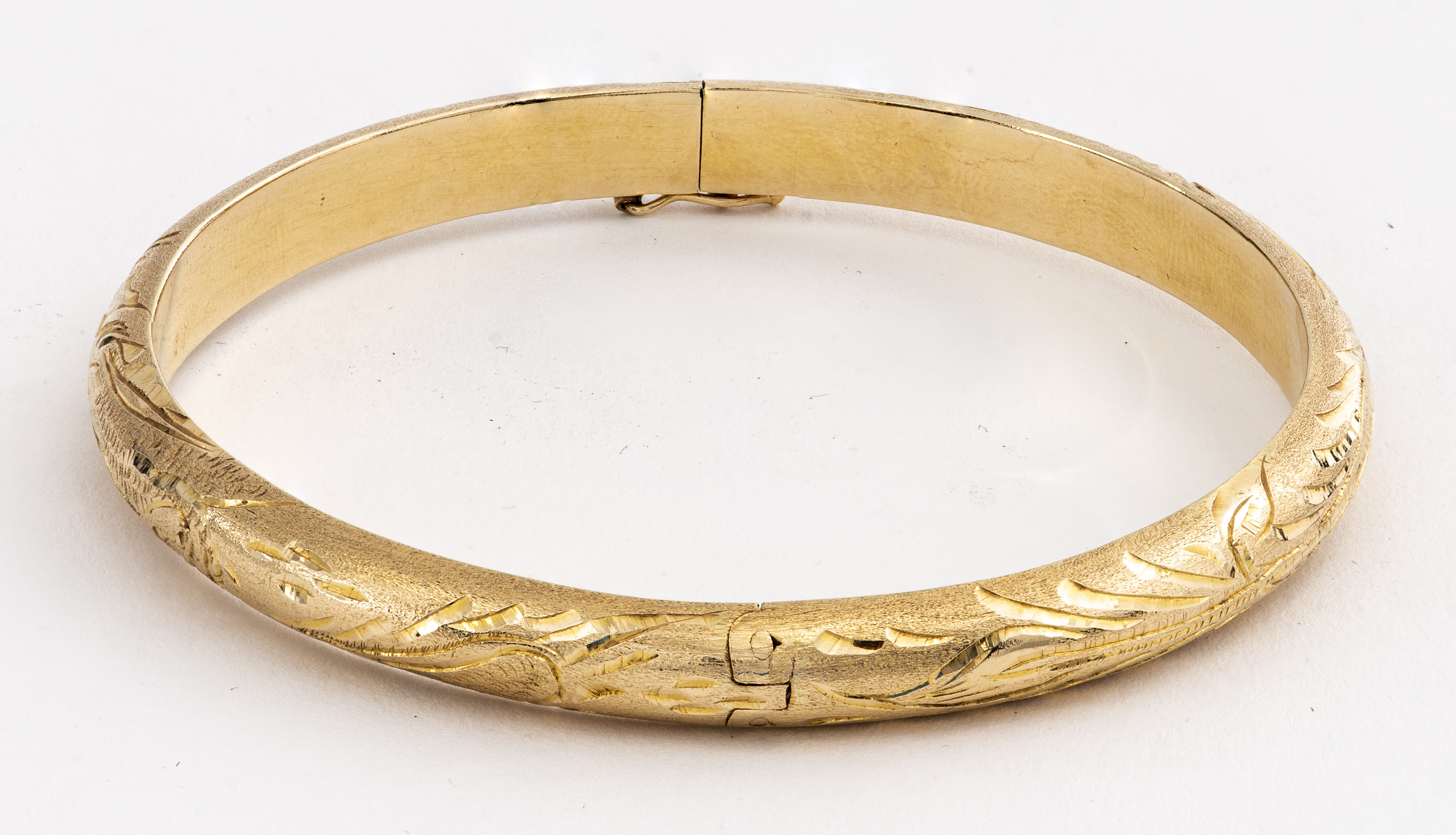 Appraisal: K GOLD DIAMOND-CUT ENGRAVED BANGLE BRACELET K yellow gold diamond-cut