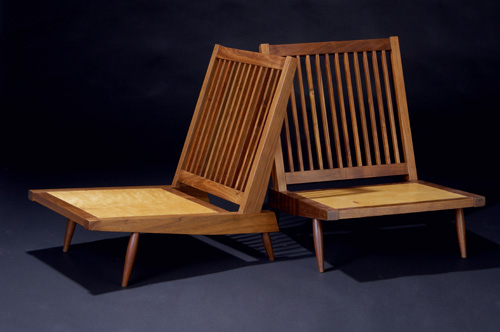 Appraisal: GEORGE NAKASHIMA Pair of walnut Cushion Chairs with Arms with