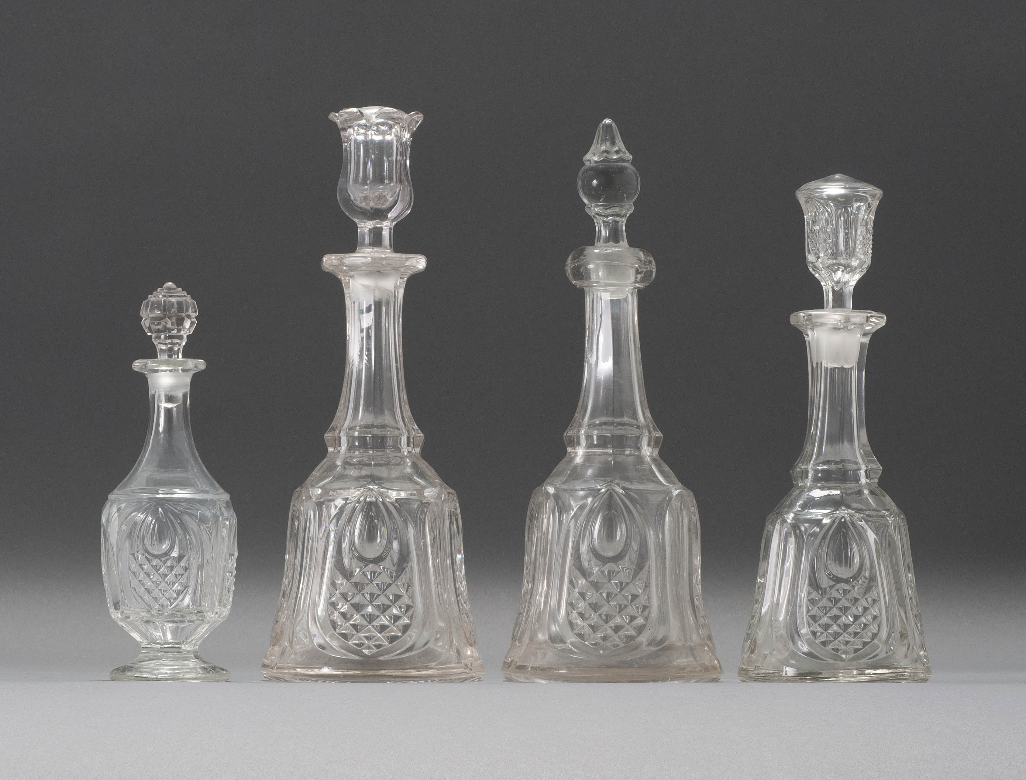 Appraisal: FOUR SANDWICH GLASS COMPANY FLINT PATTERN GLASS DECANTERS Third Quarter