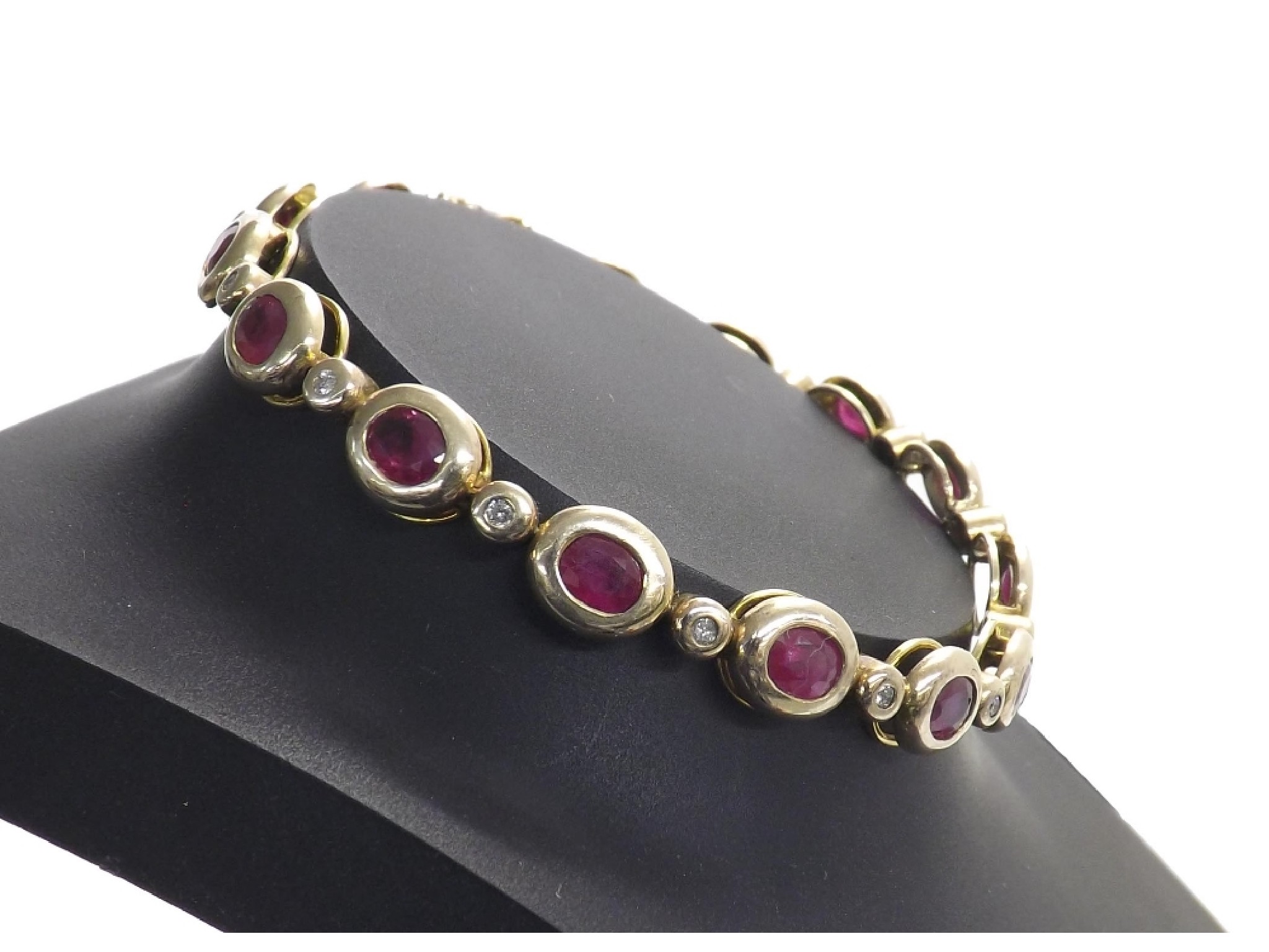 Appraisal: k ruby and diamond bracelet with fourteen oval rubies in