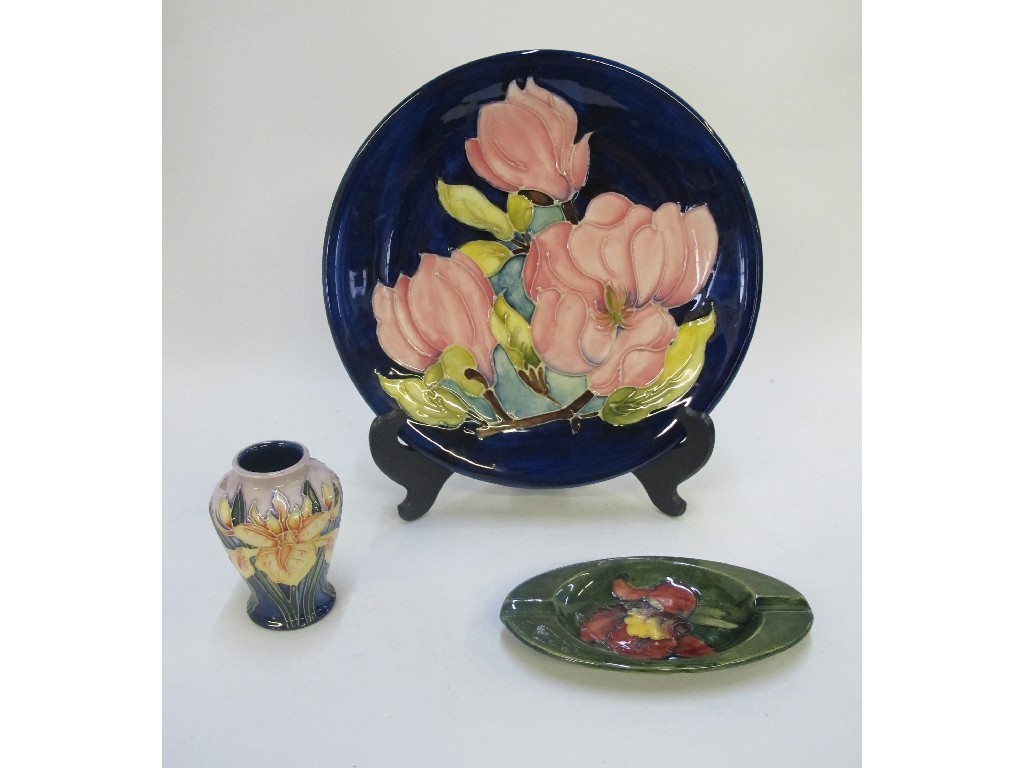 Appraisal: Moorcroft Magnolia plate orchid ashtray and Iris vase latter chipped