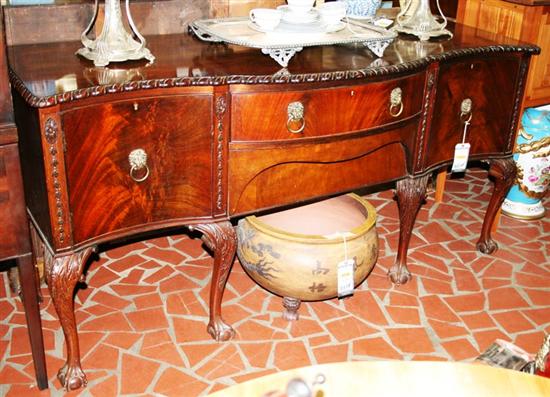 Appraisal: Chippendale style carved mahogany serpentine sideboard th century shaped top