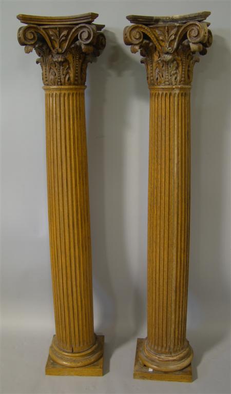 Appraisal: PAIR OF CARVED COLUMNS Wooden with corinthian capitals raised on