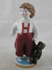 Appraisal: A Russian ceramic figure of a boy with a teddy