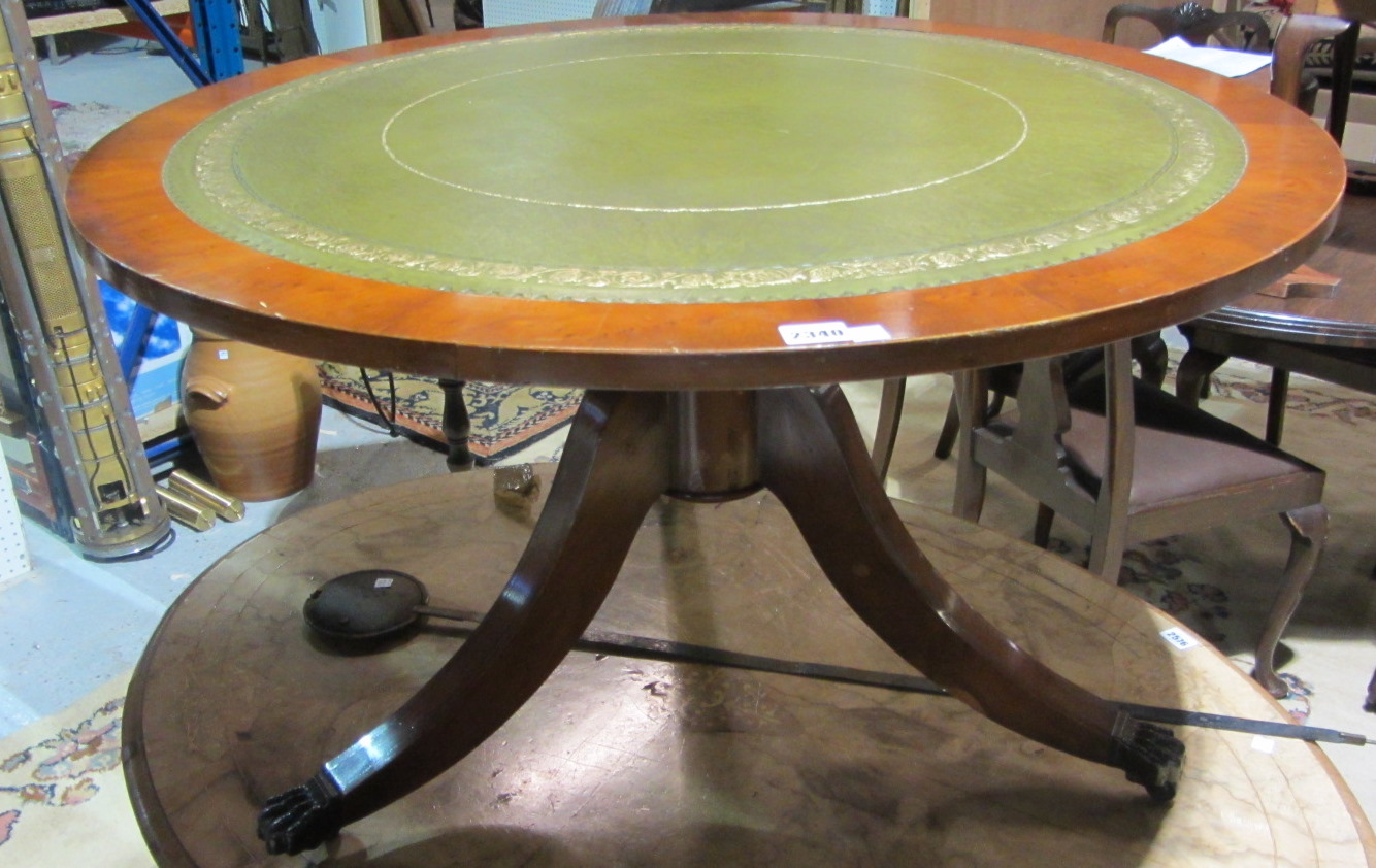 Appraisal: A th century yew circular coffee table with leather inset