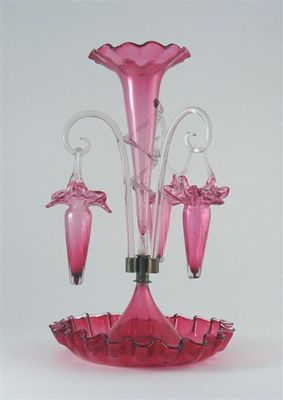 Appraisal: A cranberry glass epergne with three suspended baskets around a