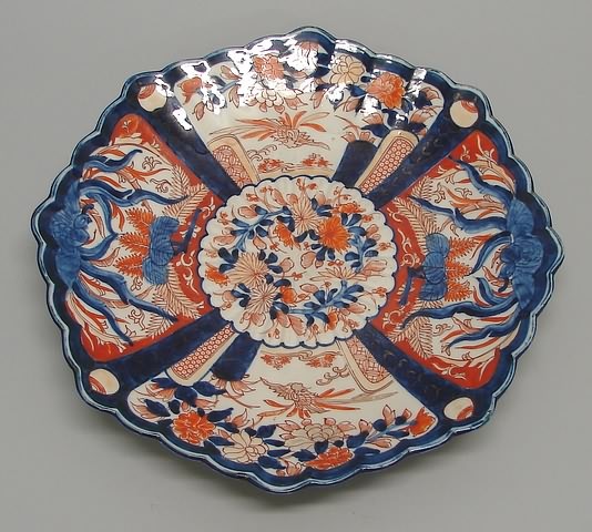 Appraisal: Plate with scalloped edge featuring two bird forms on either