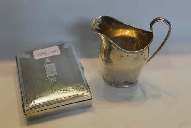 Appraisal: A GEORGIAN STYLE SILVER CREAM JUG of baluster form with